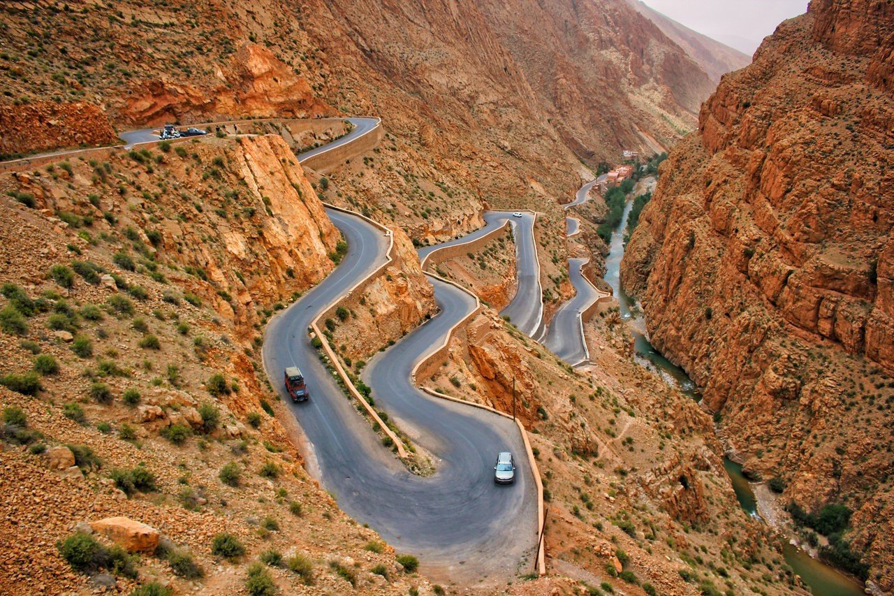 Dades Gorge Scenic Mountain Pass | Private Morocco Road Trips - Rafia Morocco Tours - Rafia Morocco Tours Winding mountain road of the Dades Gorge canyon, a scenic drive included in private tours of Morocco from Marrakech to the Sahara Desert.